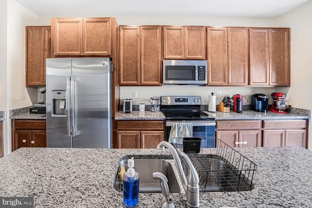 kitchen with stainless steel appliances and light stone countertops