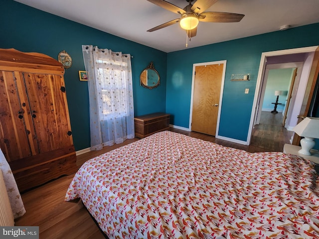 bedroom with a ceiling fan, baseboards, and wood finished floors