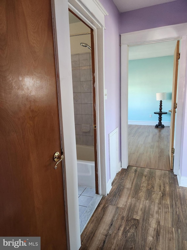 hall with wood finished floors and baseboards