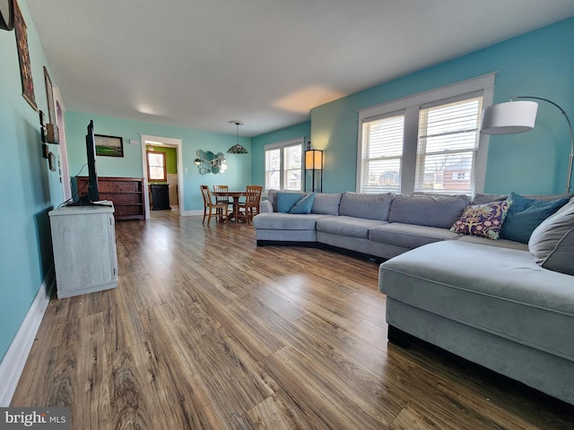 living room featuring dark wood finished floors and baseboards