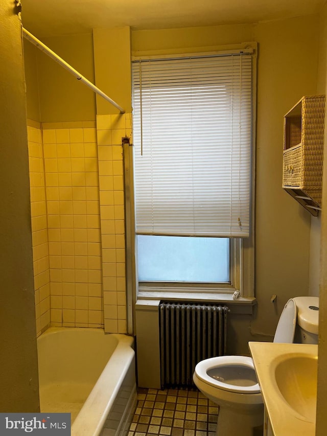 bathroom featuring shower / washtub combination, toilet, radiator heating unit, tile patterned floors, and vanity