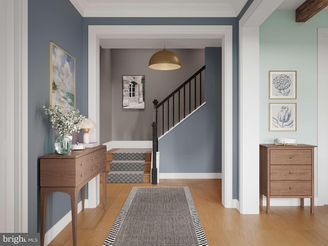 entrance foyer with baseboards, crown molding, stairway, and wood finished floors