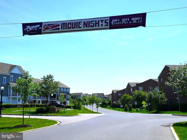 view of road featuring street lights and a residential view