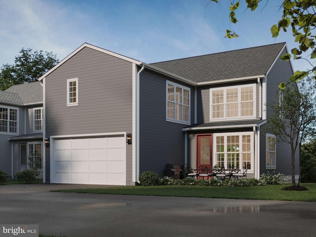 traditional-style house with a garage and driveway