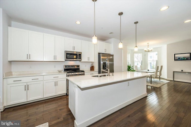 kitchen with a sink, dark wood-type flooring, white cabinetry, and stainless steel appliances