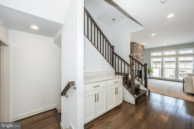 stairway featuring recessed lighting, baseboards, and hardwood / wood-style flooring