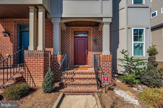 doorway to property with brick siding