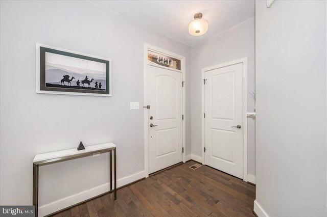 entryway with baseboards and dark wood-style flooring