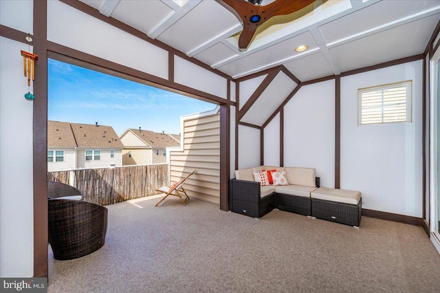 sunroom with beamed ceiling, a residential view, and coffered ceiling