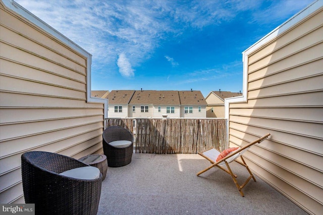 view of patio with a residential view and a balcony