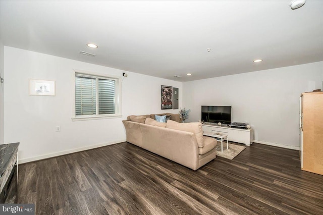 living area with dark wood finished floors, visible vents, recessed lighting, and baseboards