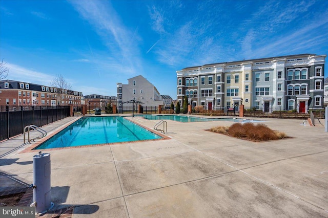 community pool featuring a patio and fence