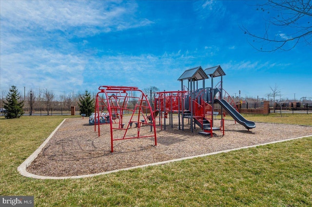 community playground featuring a yard and fence