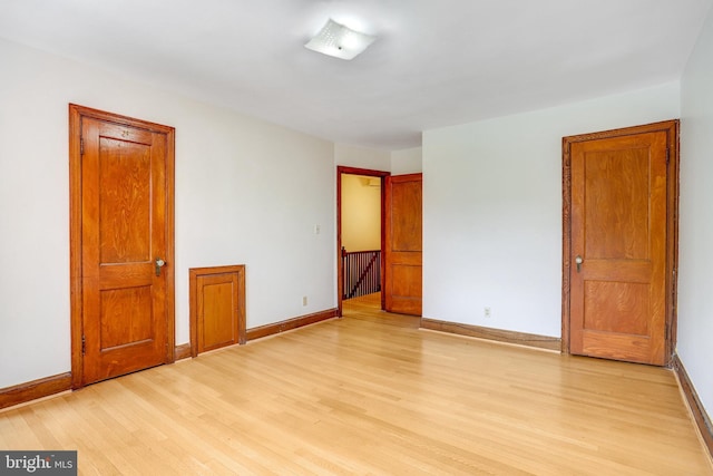 unfurnished room featuring light wood-style floors and baseboards