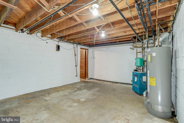 unfinished basement featuring water heater and a heating unit