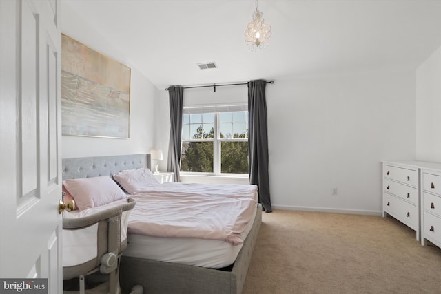 bedroom with visible vents, baseboards, and light colored carpet