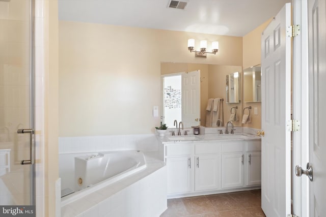 full bath featuring a stall shower, visible vents, a whirlpool tub, and a sink