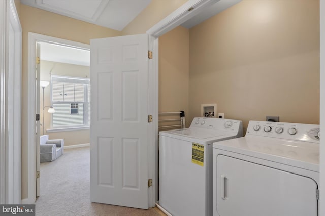 washroom featuring laundry area, separate washer and dryer, baseboards, and light carpet