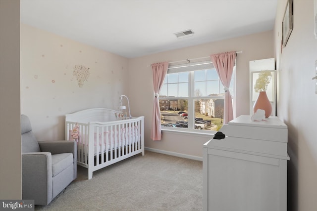 bedroom with a nursery area, baseboards, carpet, and visible vents