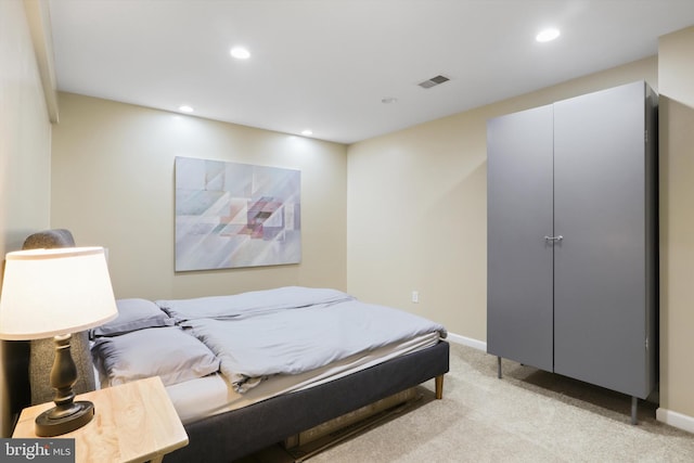 bedroom with recessed lighting, visible vents, light colored carpet, and baseboards