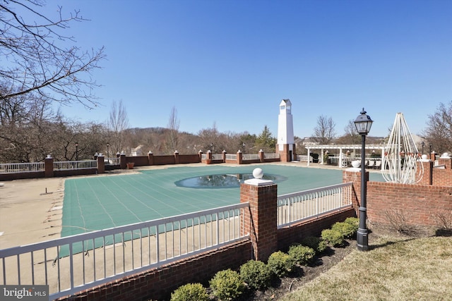 view of swimming pool with fence