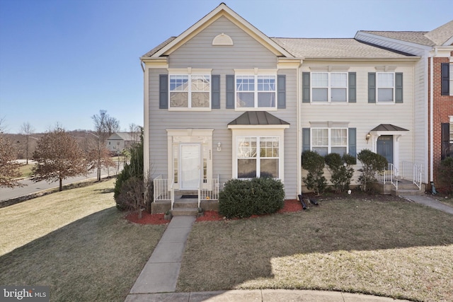 view of property featuring a front lawn