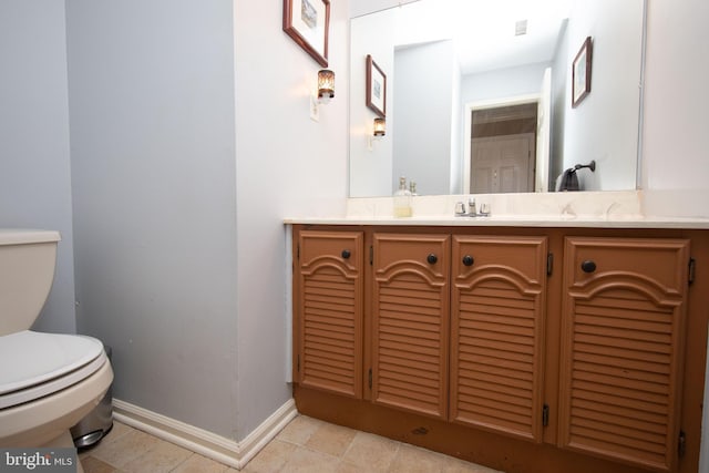 bathroom featuring toilet, visible vents, baseboards, and vanity