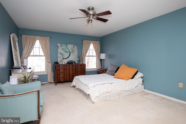 bedroom with multiple windows, carpet flooring, a ceiling fan, and baseboards