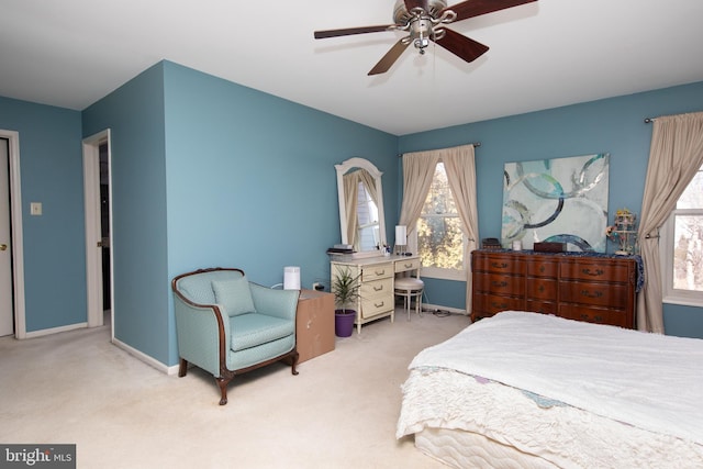 bedroom with a ceiling fan, carpet flooring, and baseboards