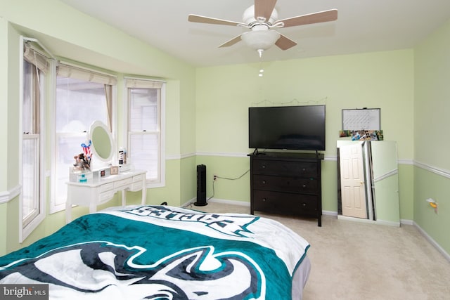 carpeted bedroom with vaulted ceiling, a ceiling fan, and baseboards