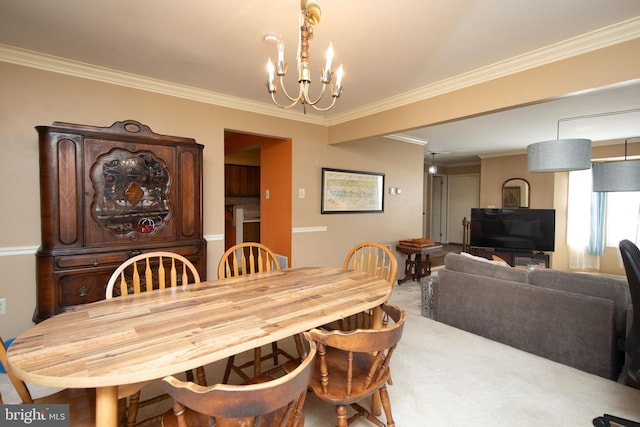 carpeted dining room featuring a chandelier and ornamental molding