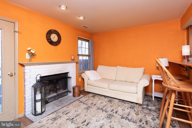 living area featuring visible vents, a fireplace, and baseboards