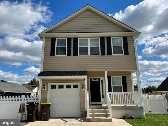 view of front of house with covered porch, concrete driveway, fence, and a garage