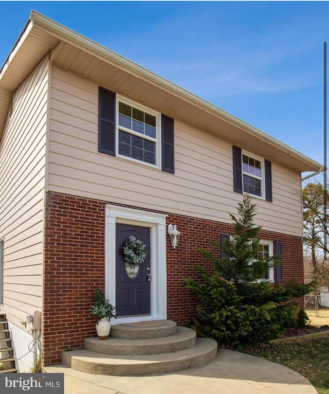 view of front of house with brick siding