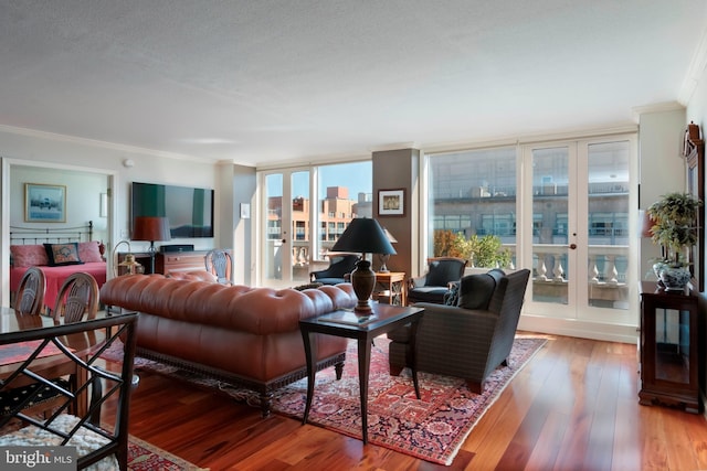 living area featuring ornamental molding and hardwood / wood-style flooring