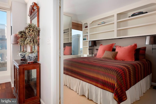 bedroom with baseboards and wood finished floors