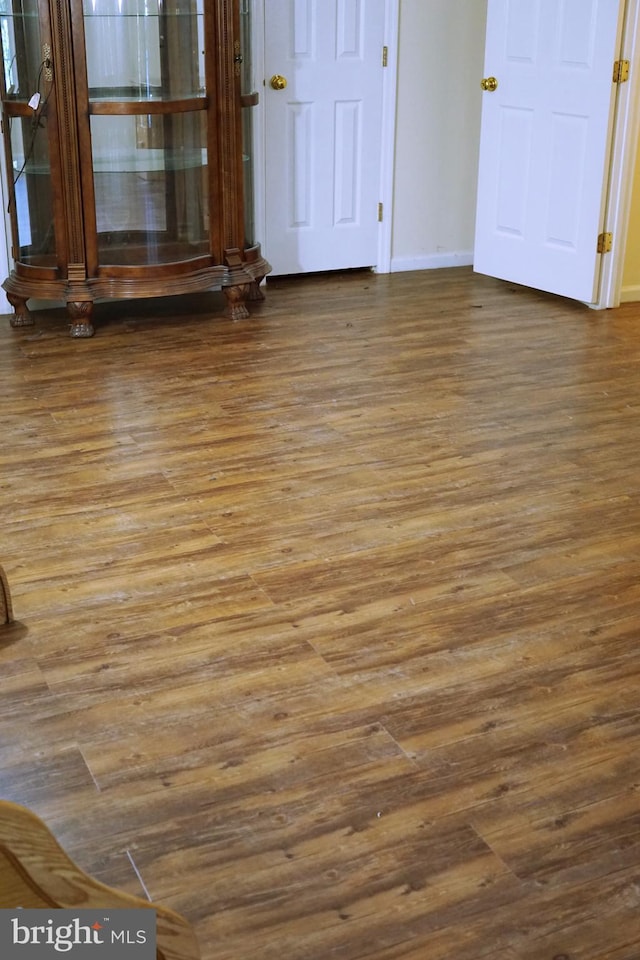 unfurnished room featuring wood finished floors and baseboards