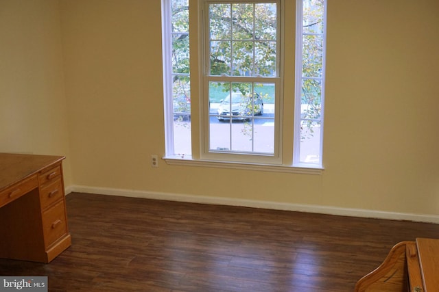 interior space featuring baseboards and wood finished floors