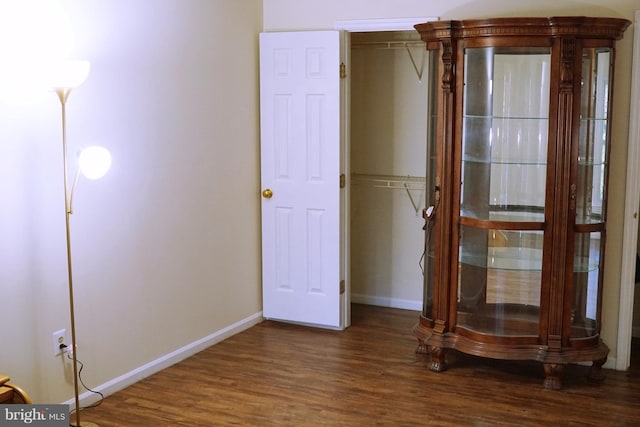 unfurnished bedroom featuring baseboards and wood finished floors