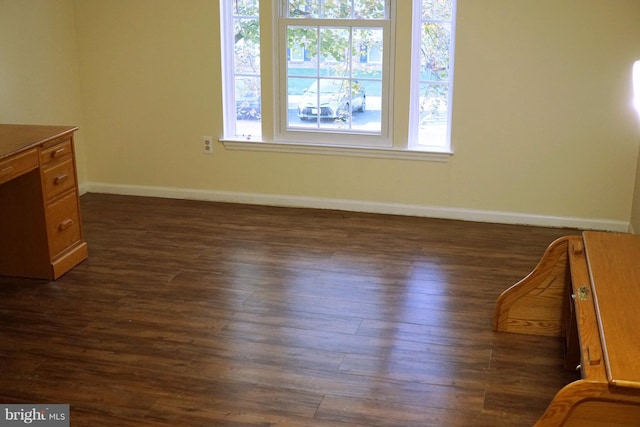 interior space with dark wood-style flooring and baseboards