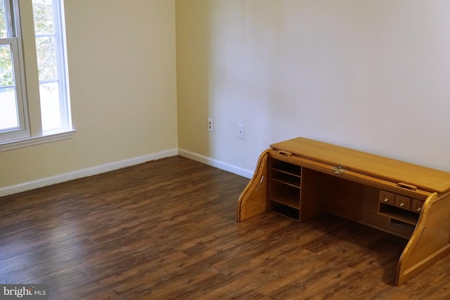 interior space with dark wood-style flooring and baseboards