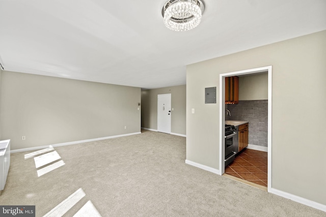 unfurnished bedroom with an inviting chandelier, electric panel, baseboards, and carpet flooring