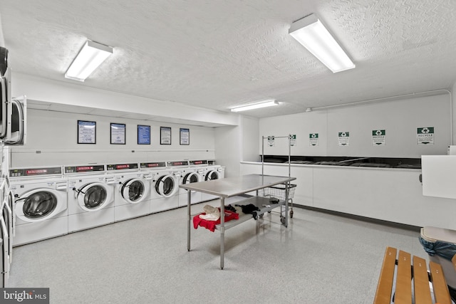 shared laundry area with stacked washer / drying machine, a textured ceiling, and washing machine and clothes dryer