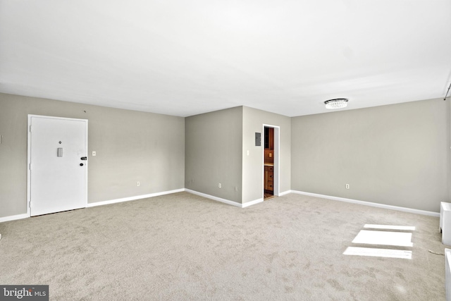 carpeted empty room with baseboards