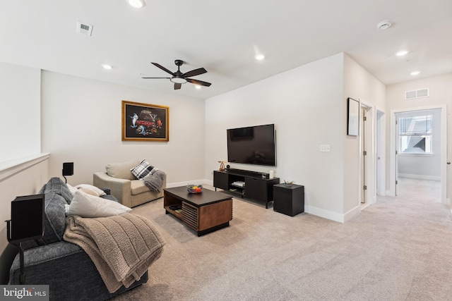 living room featuring recessed lighting, light colored carpet, and visible vents