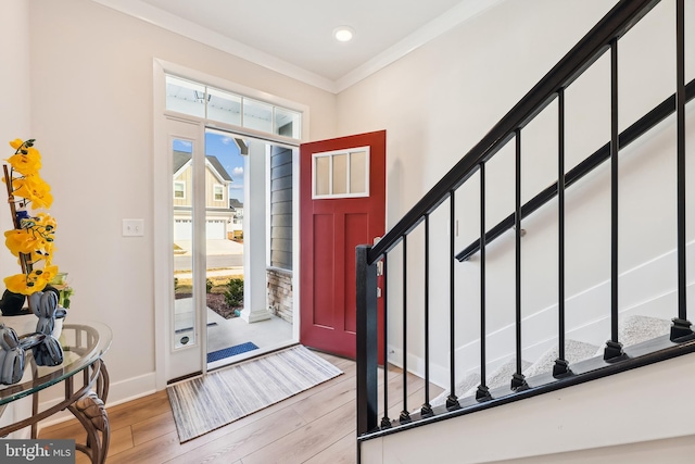 entryway featuring baseboards, recessed lighting, stairs, light wood-style floors, and crown molding