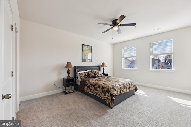 bedroom featuring visible vents, carpet floors, baseboards, and a ceiling fan