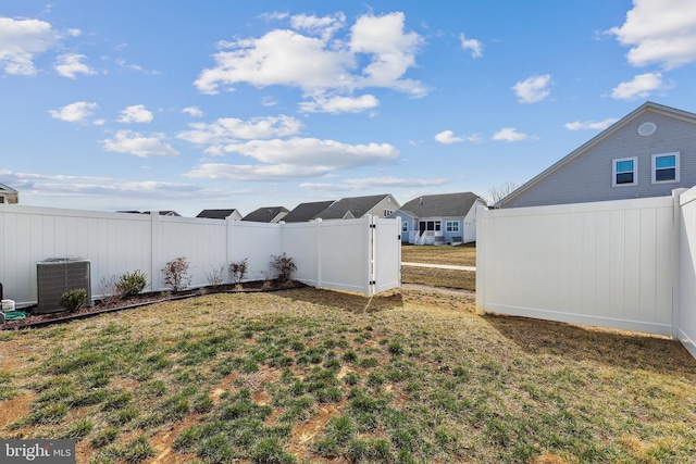 view of yard with cooling unit and fence