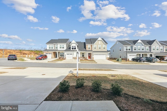 view of yard with concrete driveway and a residential view