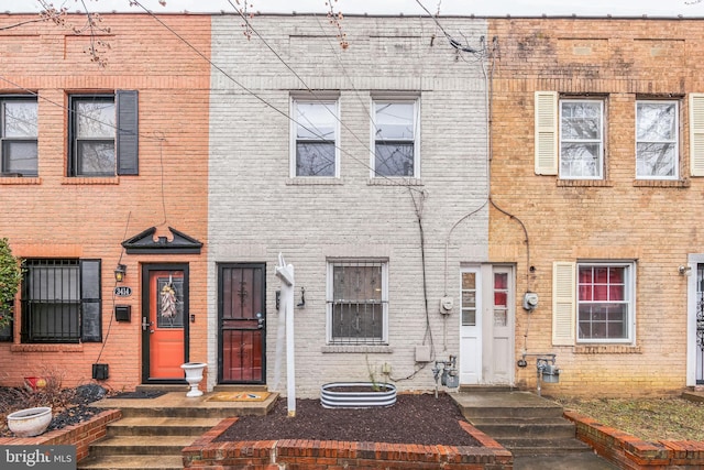 townhome / multi-family property featuring brick siding